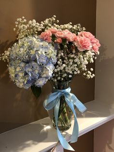 two vases filled with blue and pink flowers