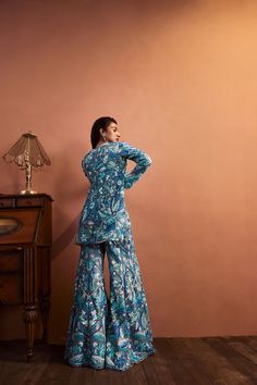 This blue-green jacket set features all over thread work with tonal sequins. It is paired with an embroidered bustier and high waist sharara pants.From Seema Gujral’s Fiori collectionDELIVERY TIMEPlease allow 8-12 weeks for your outfit to arriveFABRIC DETAILSNetProfessional cleaning only Embroidered Bustier, Seema Gujral, Sharara Pants, Work Jacket, Work Jackets, Thread Work, Pant Set, Green Jacket, Festival Wear