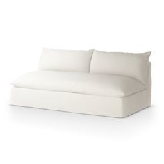 a white couch sitting on top of a white floor