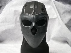 Become the scary Deimos from Rainbow 6 wearing this stunning mask. Hand painted and fitted with tinted lenses. Tactical black balaclava and eco leather straps complete the look.  Make your enemies fear your very presence wearing our top quality face mask! 🎭 Step into the shoes of the enigmatic Deimos from Rainbow 6 with this exquisitely crafted mask! 🌈 Immerse yourself in the tactical world of R6 as you don this stunning Deimos operator mask. 🎨 Meticulously hand-painted and detailed, this rep Black Post-apocalyptic Masks And Prosthetics For Cosplay, Post-apocalyptic Full Face Black Mask, Black Post-apocalyptic Mask For Cosplay, Black Post-apocalyptic Style Mask For Cosplay, Futuristic Black Masks And Prosthetics For Streetwear, Cyberpunk Full Face Protection Mask, Cyberpunk Full Face Mask For Protection, Full Face Cyberpunk Protection Masks, Full Face Black Masks For Cosplay