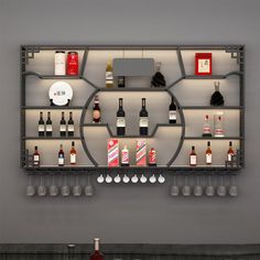 a wall mounted wine rack filled with lots of bottles and glasses on top of a counter