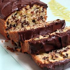 a loaf of chocolate chip banana bread cut in half and sitting on top of a plate