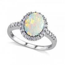 a white opal and diamond ring with an oval center surrounded by small round diamonds