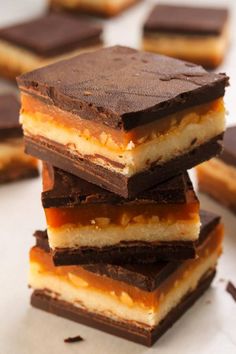 several pieces of chocolate and peanut butter bars stacked on top of each other