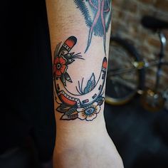 a woman's arm with a tattoo on it and a bird in the middle