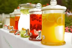 several jars filled with liquid sitting on top of a table