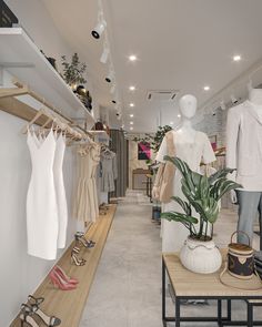 a clothing store with clothes and shoes on display