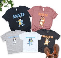 three t - shirts with cartoon characters on them, one for dad and the other for sister