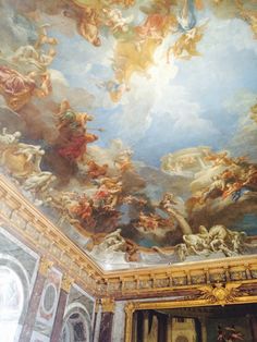 an ornate painting on the ceiling of a building