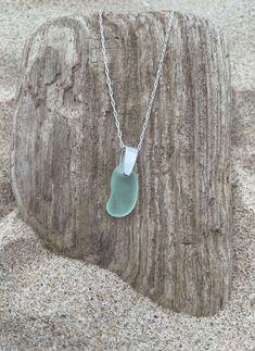 Authentic Seafoam Sea Glass Necklace, Genuine Beach Glass Pendant, Sterling Silver Jewelry, Perfect Gift for Her or Yourself with Free Shipping This is a classic, elegant beach glass pendant necklace accented with a sterling silver bail. An 18 inch sterling silver chain can be included. This handmade beach glass jewelry gift is from authentic beach glass hand-picked on the shores of Lake Michigan. The beautiful seafoam color of the sea glass has been emphasized with the addition of a small amount of baby oil. Each piece is unique and at jewelry grade quality. The necklace photos on the listing are the exact item you will receive. The necklace is ready for gifting with a beautiful silver jewelry box included. Sea glass dimensions: 0.75 x 0.5 inches FREE Shipping to all U.S. mainland address Beach Glass Jewelry, Seafoam Color, Silver Jewelry Box, Beachglass Jewelry, Sea Glass Necklace, Glass Pendant Necklace, Baby Oil, Classic Elegant, Beach Glass