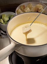 a pot filled with soup sitting on top of a stove