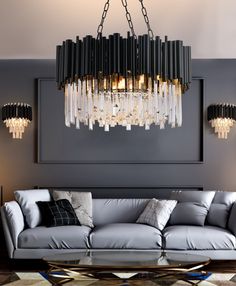 a living room filled with furniture and a chandelier hanging over the couches