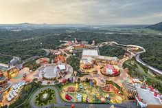 an aerial view of a theme park at dusk with lots of rides and carnival rides