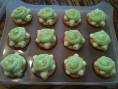 twelve cupcakes with green frosting in the shape of turtles