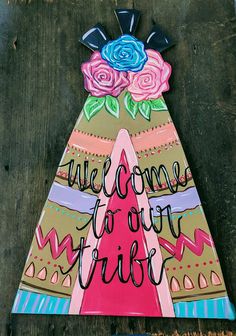 a wooden sign that says welcome to your tribe with flowers on it and the words,'welcome to your tribe '