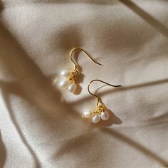 P R O D U C T D E T A I L S Main Stone: Shell Pearl Main Stone Size: 5mm * 6mm Earring Height: 22mm M A T E R I A L S Metal Material: Solid 925 Sterling Silver Metal Electroplating: 18K Yellow Gold H A P P I N E S S G U A R A N T E E D We Believe in 100% Happiness = 100% Satisfaction - Quality products guaranteed. Classic Dangle Cluster Earrings Gift, Classic Dangle Cluster Earrings For Gift, Elegant Tiny Teardrop Earrings, Dainty Hypoallergenic Cluster Earrings As Gift, White Earrings For Anniversary, Elegant Small Earrings, Classic Teardrop Cluster Earrings As Gift, Tiny White Round Earrings, Elegant Small Hypoallergenic Earrings