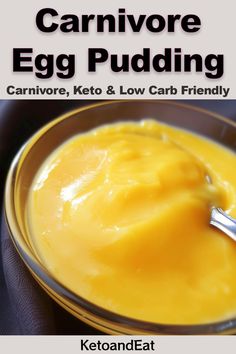 an egg pudding in a yellow bowl with a silver spoon on it and the words, carnivore egg pudding