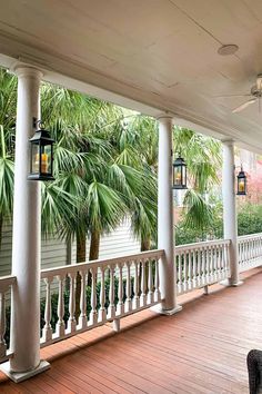 the porch is lined with palm trees and lanterns