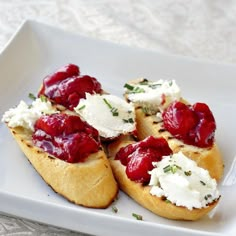 crostini with cream cheese and strawberries on a white plate