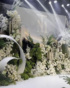 an elaborate display with white flowers and greenery