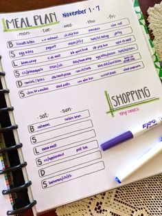 a meal planner and pen on top of a table