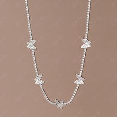 Enhance your fine jewelry collection with this exquisite cubic zirconia butterfly choker necklace. The intricate butterfly design, set on a solid 925 sterling silver chain, adds a touch of elegance to any outfit. Versatile enough to layer with longer necklaces, this piece is a must-have for any jewelry lover. Whether worn every day or for a special occasion, this necklace will make you feel like a beautiful bride. Materials: 925 sterling silver, cubic zirconiaFinish: platinum plateChoker length: Elegant Sterling Silver Butterfly Necklace With Butterfly Clasp, Delicate Butterfly Jewelry With Cubic Zirconia, White Gold Butterfly Necklace With Cubic Zirconia, Delicate Butterfly-shaped Jewelry With Cubic Zirconia, Delicate Butterfly Cubic Zirconia Jewelry, Delicate Butterfly-shaped Cubic Zirconia Jewelry, Elegant Silver Butterfly Necklace In Cubic Zirconia, Delicate Jewelry With Cubic Zirconia Butterfly Charm, Elegant Silver Butterfly Necklace With Cubic Zirconia