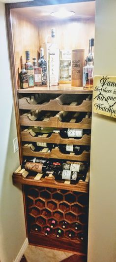 a wine rack with many bottles on top of it