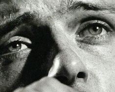 a close up of a man's face with his hand on the nose and eye