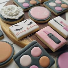 decorated cookies with makeup and eye shadows on them