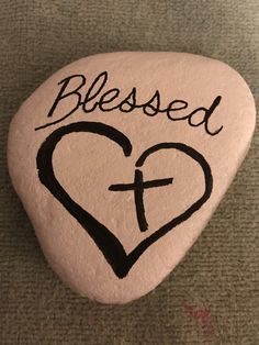 a painted rock with the words, i love you and a cross on it that says, blessed