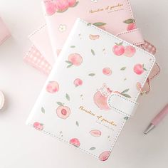 three notebooks with pink and white designs on them