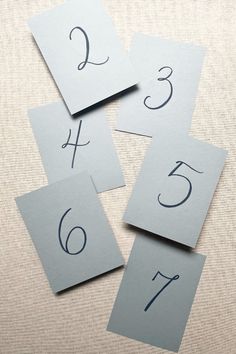 four cards with numbers on them sitting on a table