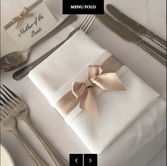 a place setting with silverware and napkins