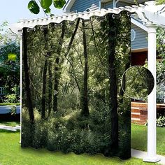 an outdoor shower curtain in the shape of a wooded area with trees and bushes on it