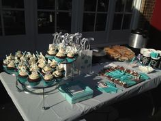 a table topped with cupcakes and desserts