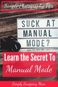 a camera sitting next to a sign with the words, learn the secret to manual mode