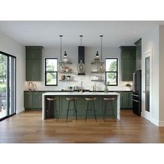 a kitchen with green cabinets and wooden floors