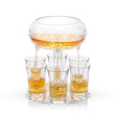 four glasses filled with liquid sitting on top of each other