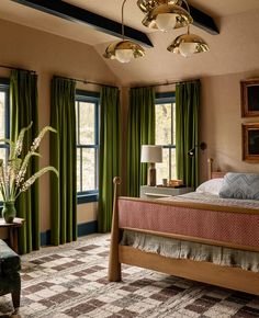 a bedroom with green curtains and a large bed