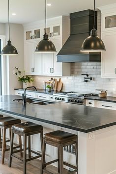 a kitchen with an island and three stools in front of the stove top oven