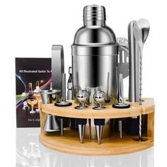 an assortment of kitchen utensils are arranged on a wooden stand with a metal cocktail shaker