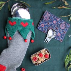 a person's feet with food and utensils laid out on a table