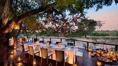 an outdoor dining area with tables and candles