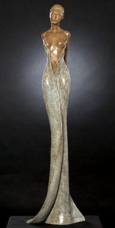 a bronze statue of a woman in a long dress