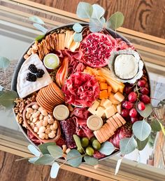 a platter filled with different types of cheeses and crackers