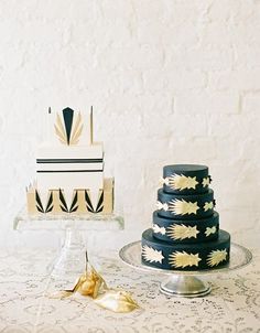 three tiered cake sitting on top of a table next to a gold leaf decoration