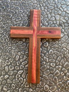 a wooden cross sitting on top of a metal surface