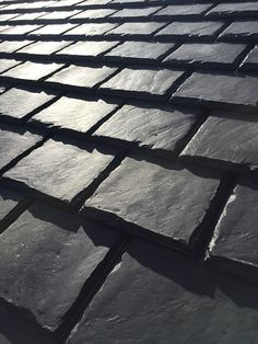 slate roof tiles are shown with the sun shining on them, and there is no image to describe