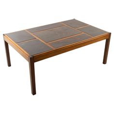 a wooden table with tile top and legs