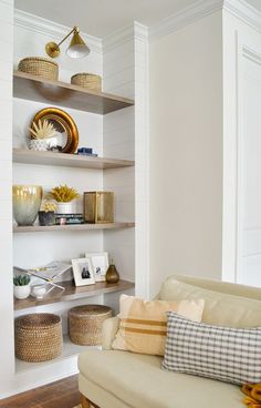 a living room filled with furniture and shelves